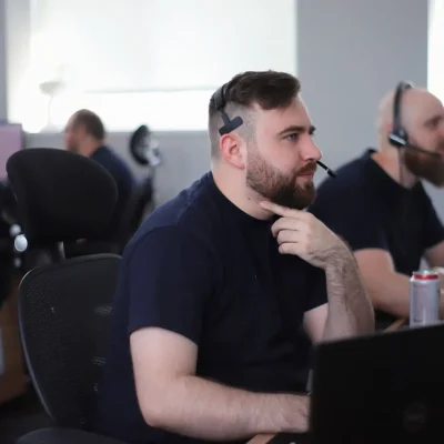 Office Shot of the commited Team Working at Their Computers Wearing Headsets