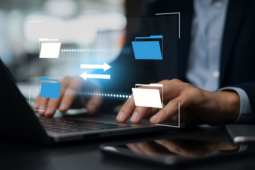 Person Using a Computer With Document Icons Above it