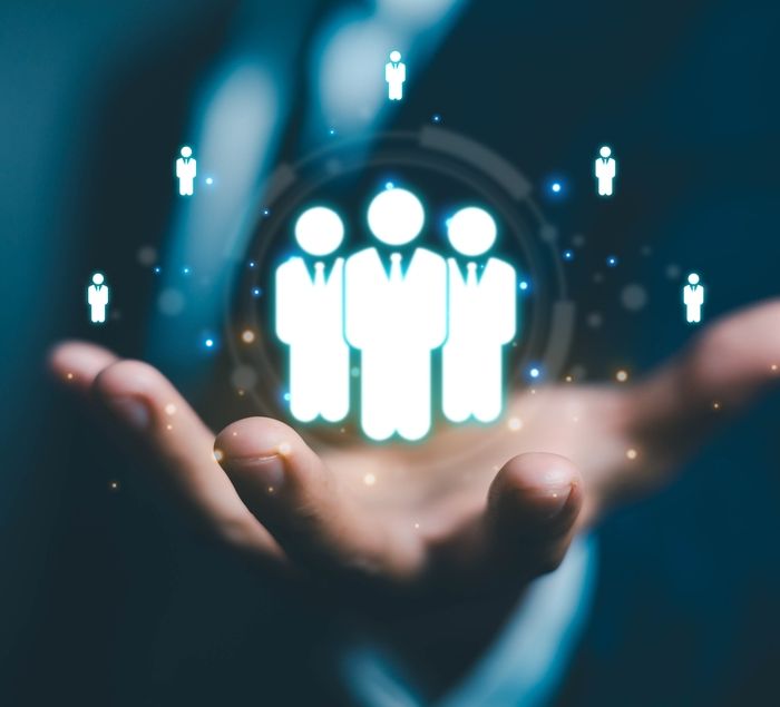 Persons Hand With Animated Figures Around it