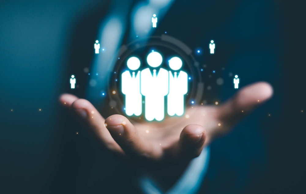 Persons Hand With Animated Figures Around it