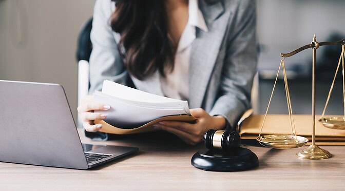Lawyer Sitting at a Desk Reading Through Documents