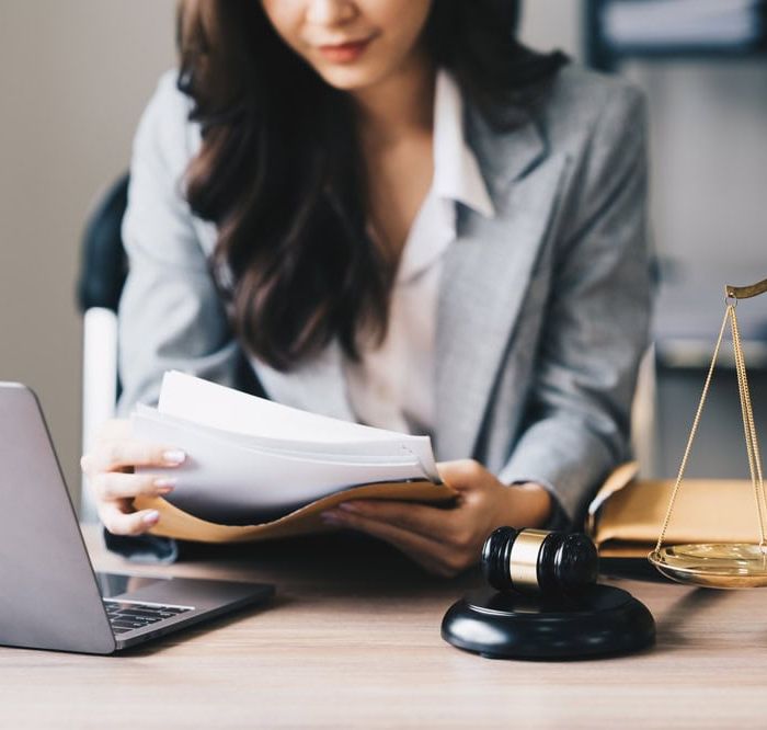 Lawyer Sitting at a Desk Reading Through Documents