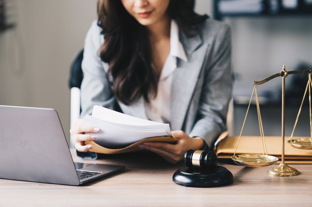 Lawyer Sitting at a Desk Reading Through Documents
