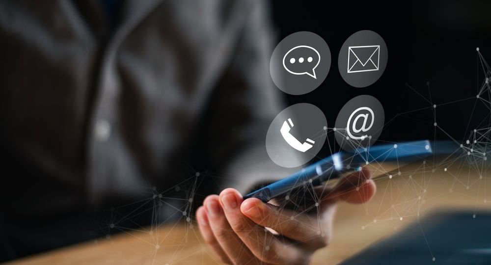 Person Holding a Mobile Phone with Four Icon Options Above it