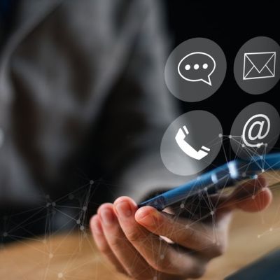 Person Holding a Mobile Phone with Four Icon Options Above it