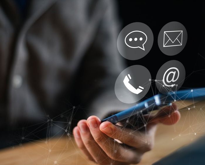 Person Holding a Mobile Phone with Four Icon Options Above it