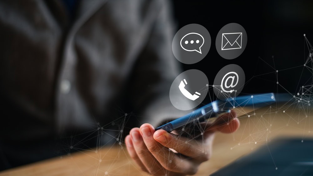 Person Holding a Mobile Phone with Four Icon Options Above it
