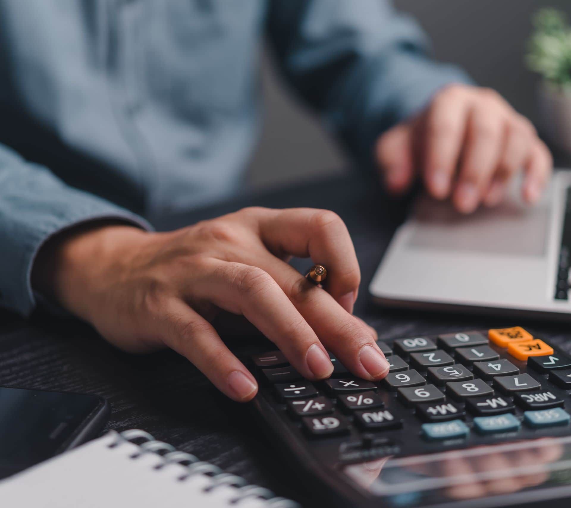 Businessman,Using,Calculator,Bookkeeping,Payroll,And,Budget,Tax.,Business,Document